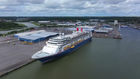 fred.olsen cruise lines passenger ship borealis alongside in port. lifeboat lowered for training. moving aerial side view.