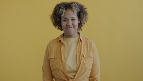 woman smiling in a yellow shirt