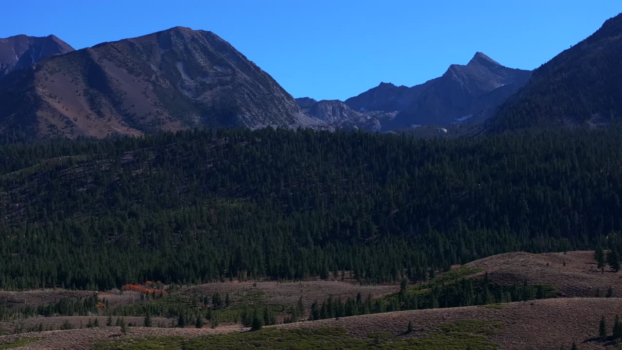 Mammoth Mountain Lakes Ski Area Sierras Nevadas Lake Mary Convict Canyon aerial drone California summer autumn fall Aspen Trees sunny blue sky Inyo National Forest circle right motion