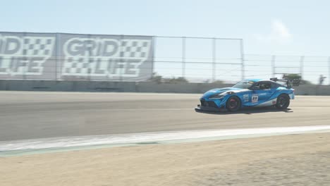 a powerful sports car accelerates on the race track, every movement of its engine and tires highlighted in crisp 60 fps slow motion.