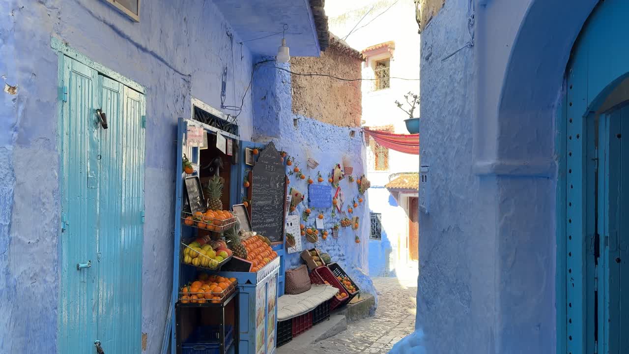 Orange stall on a picturesque blue street in Chefchaouen