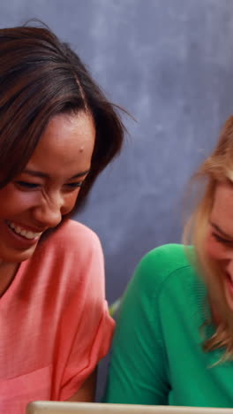 smiling friends using tablet