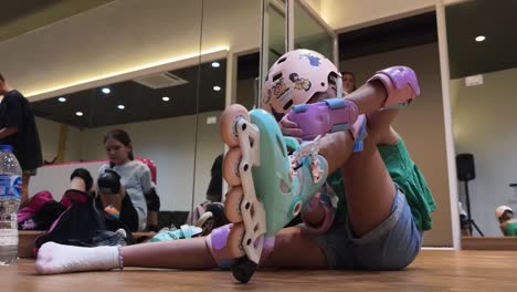 girl putting on roller skates