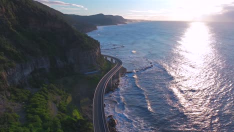 sunrise sea cliff bridge aerial drone view iconic famous stanwell park south coast nsw australia cars driving picturesque landscape royal national park wollongong coalcliff iiawarra sydney forward