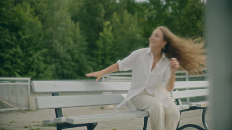 positive woman sitting on bench