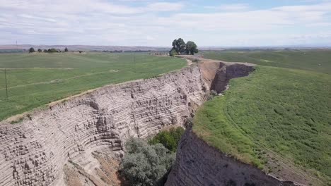 Aerial-view-of-fertile-farmland-interrupted-by-deep-eroded-gully