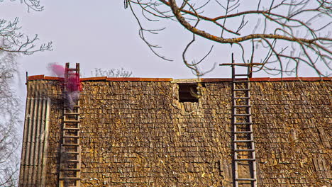 Asbestos-rooftop-removing-from-old-rural-building,-fusion-timelapse