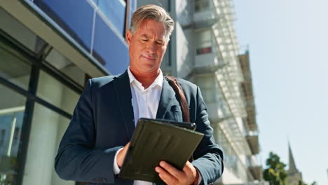 businessman working on a tablet in a city