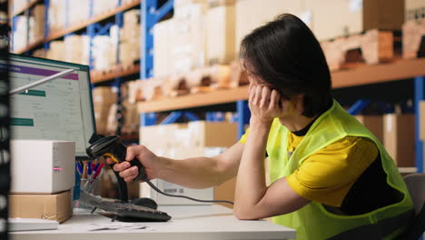 vertical video sleepy asian staff member dealing with burnout in industrial warehouse