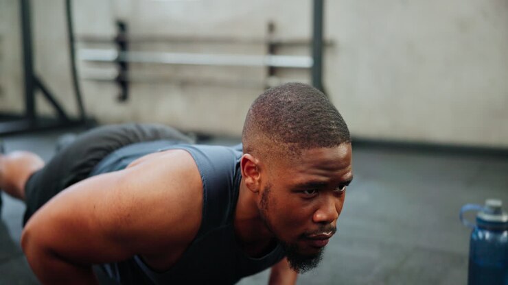 Man Doing Push-ups in a Gym