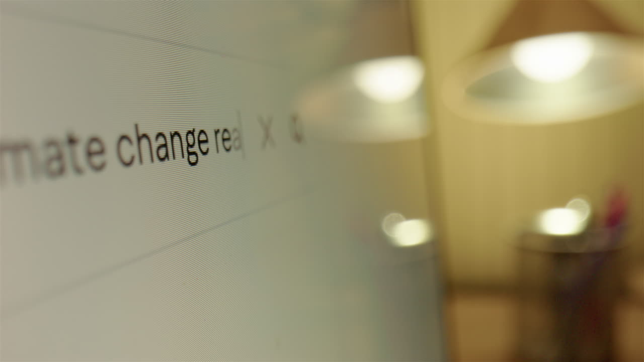 Querying whether climate change is real on internet web browser, closeup slider