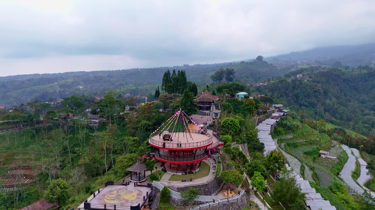 Aerial view of ketep pass tourist attraction with Tower Sky or "Menara Langit" Building. Iconic destination on the slope of Merbabu Mountain. 4K drone shot.