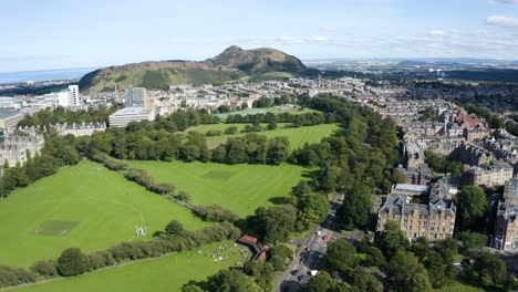 aerial shot over edinburgh university buildings and the meadows, towards arthur's seat, on a sunny day | edinburgh, scotland | 4k at 30 fps