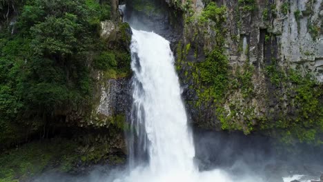 Aerial-approaching-shot-of-crashing-waterfall-in-magical-city-of-Xico,-Mexico