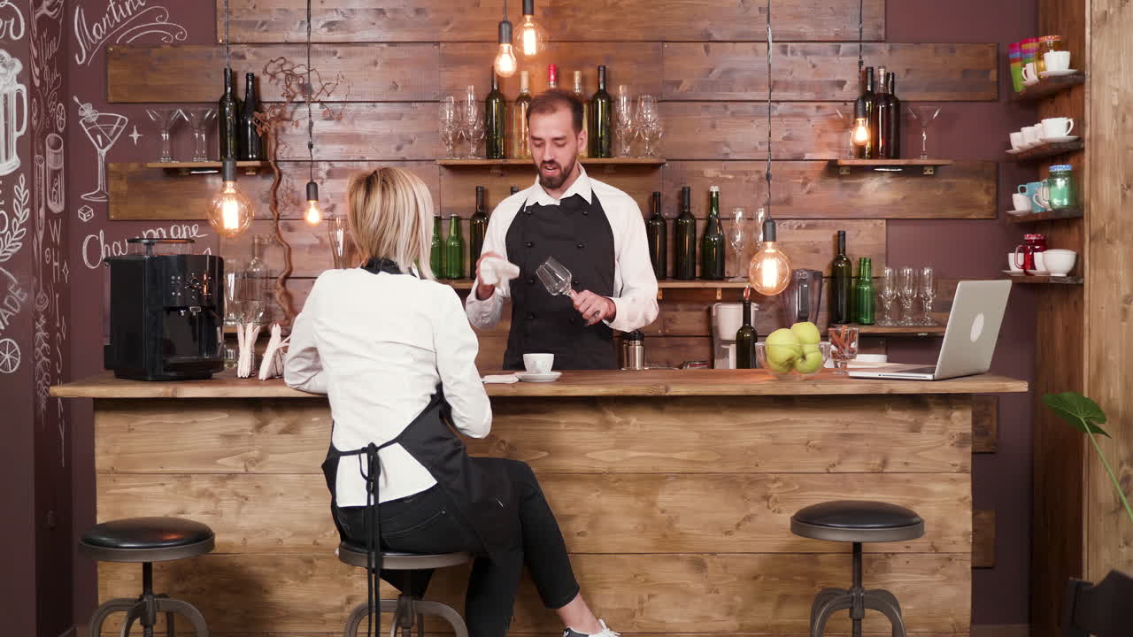 Bartender serving a customer at a wooden bar