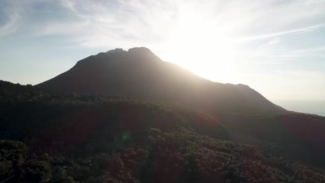 Bright-sunlight-from-sunset-behind-Hibochiboc-volcano-on-Camiguin-island