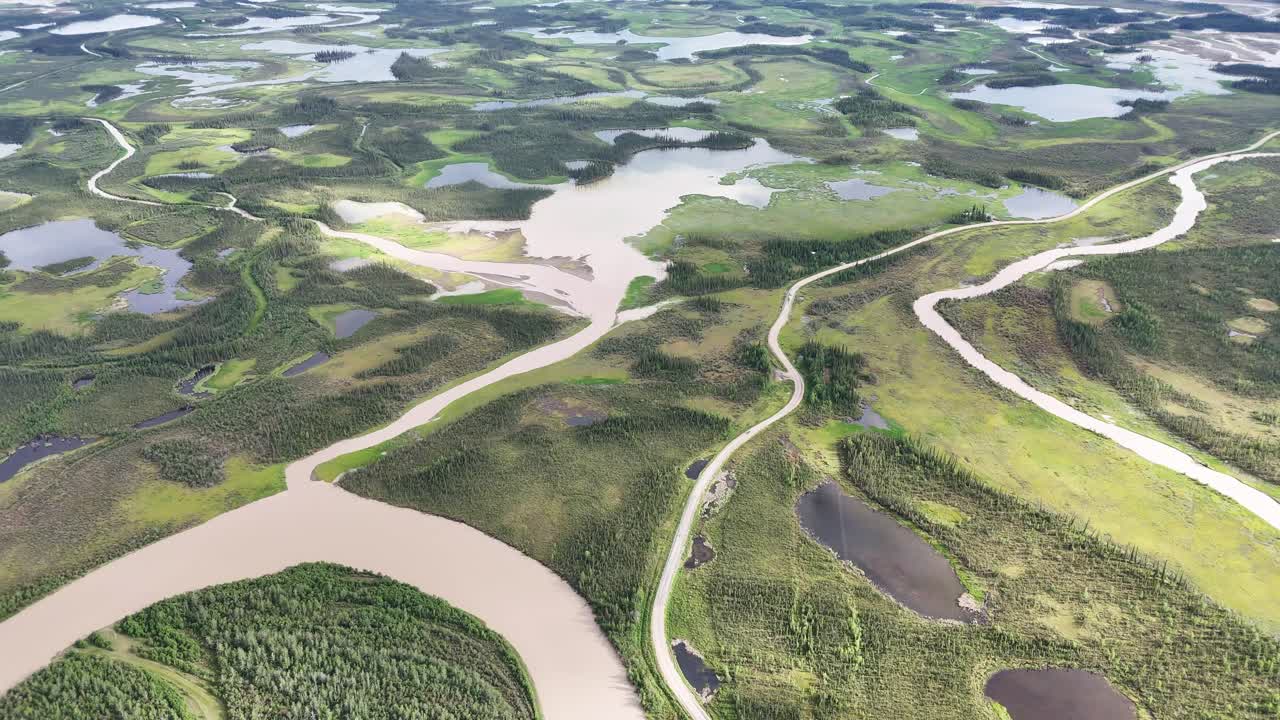 Spectacular aerial journey across winding rivers and lush green wetlands in Alaska, perfect for nature documentaries or environmental awareness campaigns