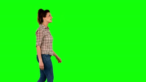 casual brunette walking on green screen