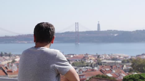 a young man looks at the bridge on april 25 in the portuguese city of lisbon
