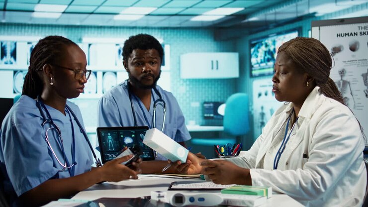 Male and female nurses in scrubs engaged in professional training and research