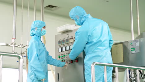 making medicine factory, medical staff in protective uniform work using tablets to walk and communicate with pharmaceutical facilities at drug manufacturing plant