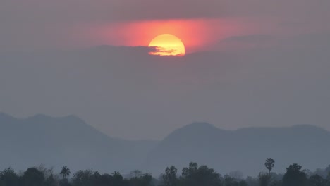 scene nature beautiful big sunset on sky in the evening. background red sunset full and mountain, forest