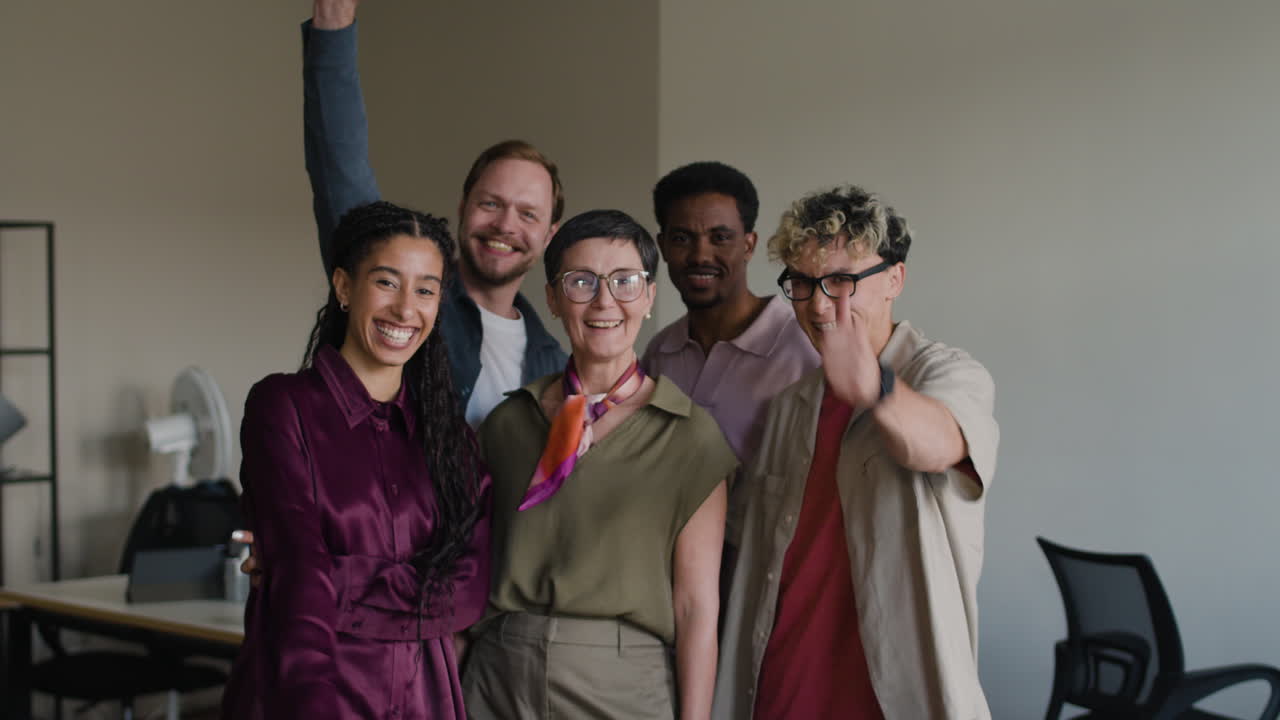 A diverse group of smiling colleagues in an office setting.