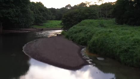 Tour-boats-on-the-Tarcoles-river-Costa-Rica-parked-on-sand-bank,-Aerial-dolly-in-shot