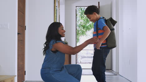 Mother-Saying-Goodbye-To-Son-As-He-Leaves-Home-For-School