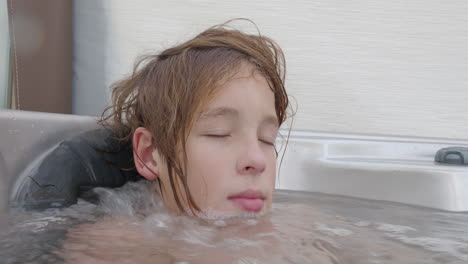 teen enjoys in a hot tub