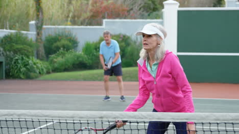 Senior-woman-playing-tennis-in-tennis-court-4k