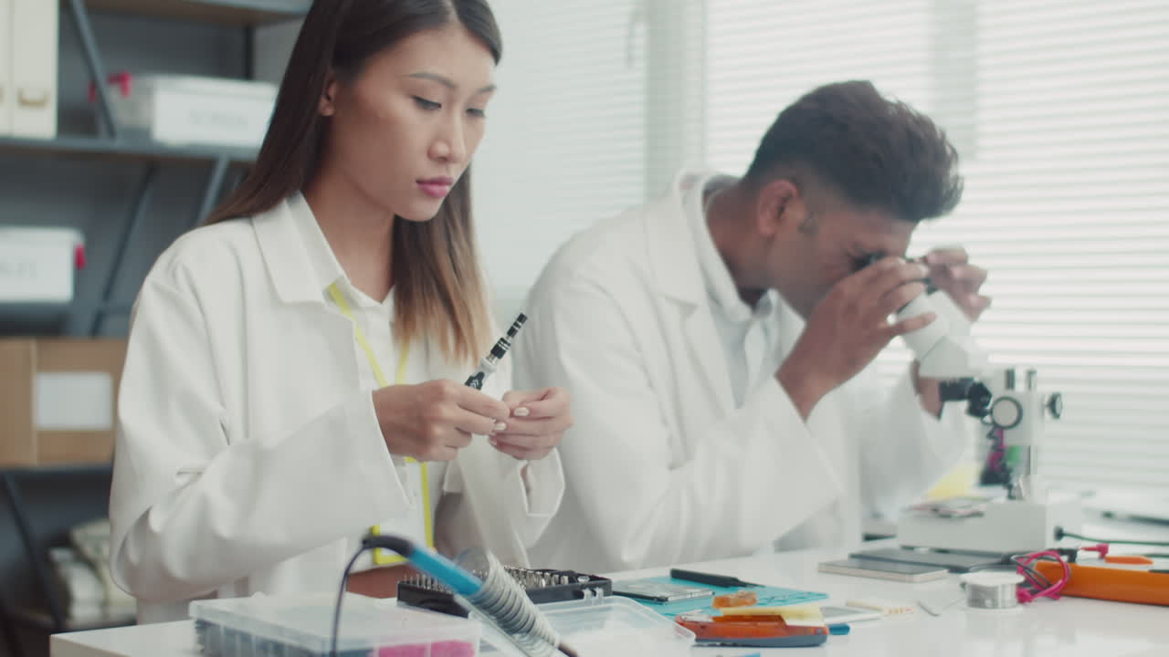 Colleagues Repairing Electronics at Service Center