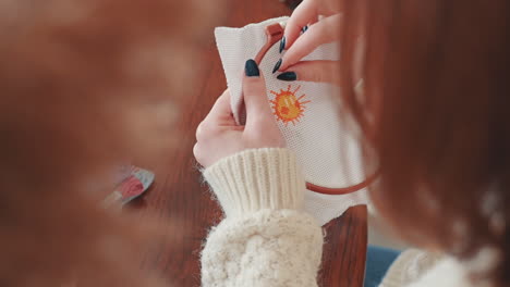 An-Unrecognizable-Red-Haired-Woman-Cross-Stitching