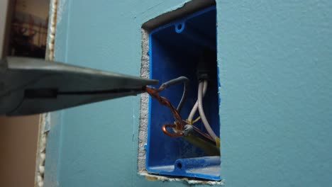 messing with and separating a few copper wires in a house in a light switch box