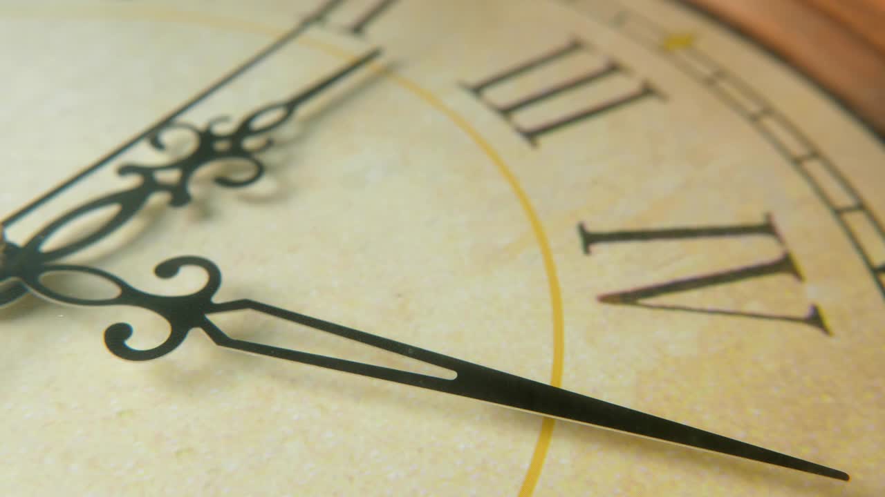 Clock face with Latin numbers and arrows pointing twenty-five minutes past two