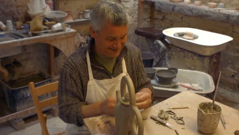 potter working on clay sculpture