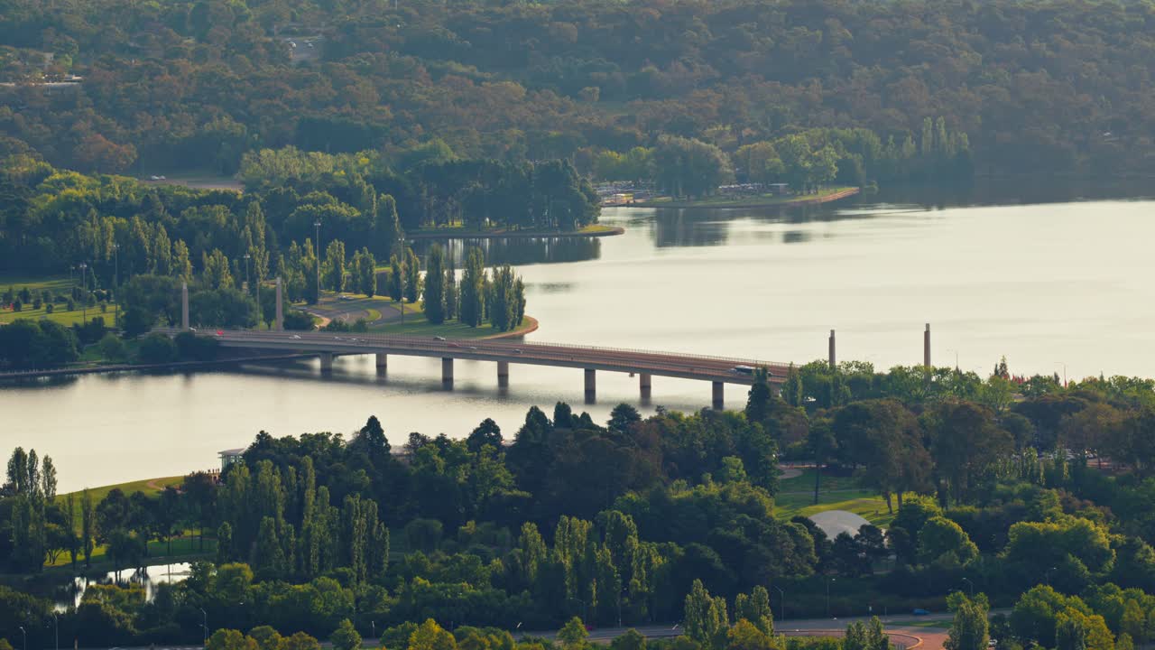 Cars cross the bridge over Lake Burley Griffin, offering views of the scenic lake and connecting major precincts in Canberra’s cityscape.