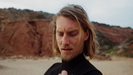 man in wetsuit on beach