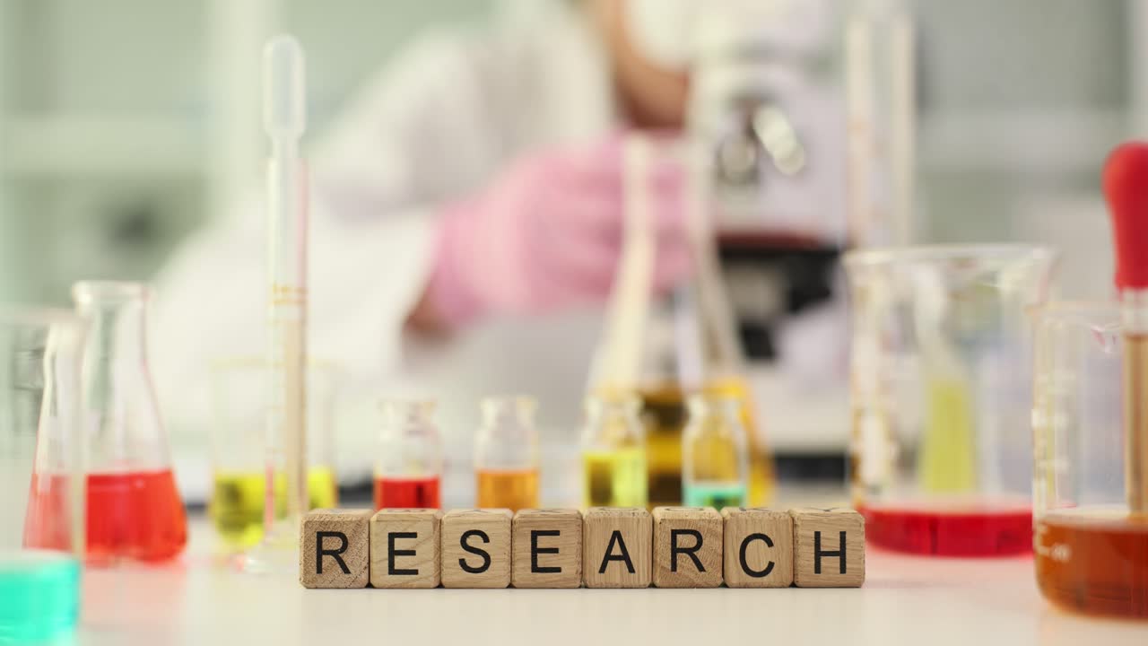 Wooden blocks spelling RESEARCH in a science laboratory
