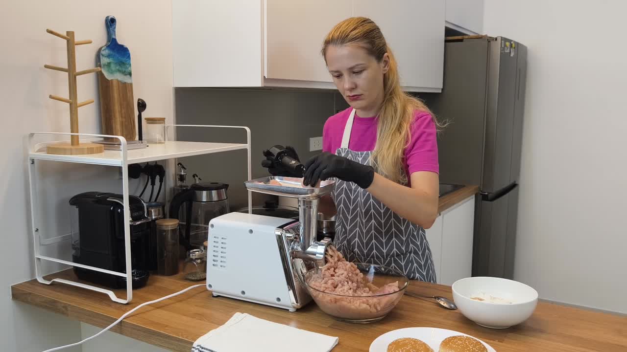 una mujer haciendo carne molida para hamburguesas.