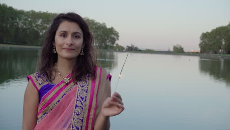 An-Young-and-beautiful-woman-in-a-traditional-sari-playing-with-fire-sparkle