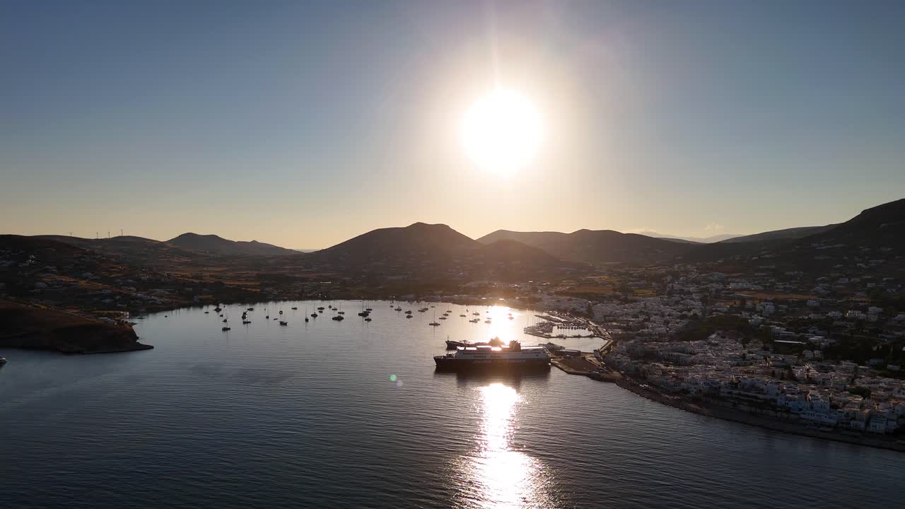 Low sun reflects beautifully off the water in the bay on the island of Paros, Greece