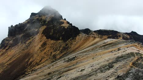 Drone-shot-flying-over-striped-volcanic-rock-in-the-Colombian-Andes