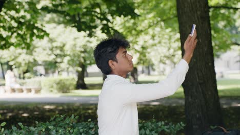 Handsome-entrepreneur-taking-selfie-in-park-on-sunny