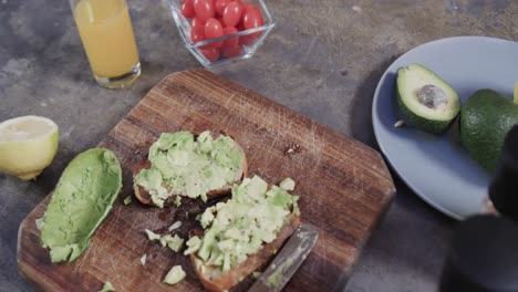 close up of avocado toast, vegetables and juice in kitchen, slow motion