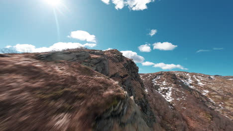 mountain ridge trail with rocks under a bright sky, evoking solitude and freedom