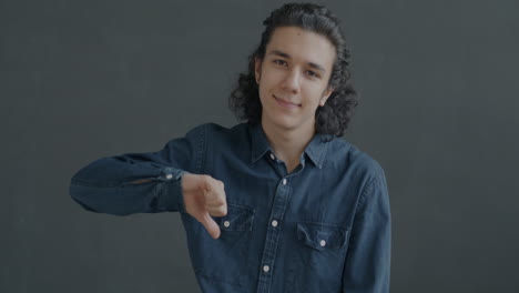 teenager giving a thumbs down