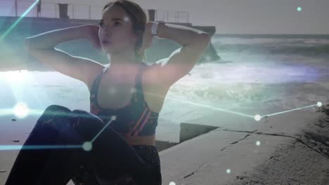 red brillante de conexiones contra mujer caucásica haciendo ejercicio de abdominales en la playa