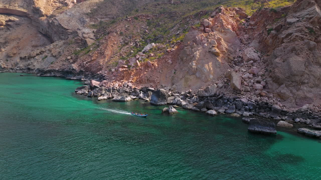 Boating Along Shoab Coast With Rocky Cliffs In Socotra, Yemen. - aerial shot