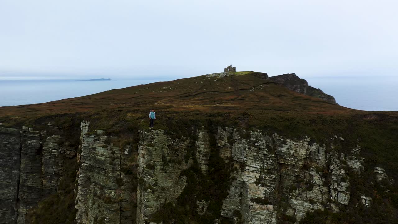 Person Running Along Cliff's Edge of Horn Head, Ireland - Aerial Tracking